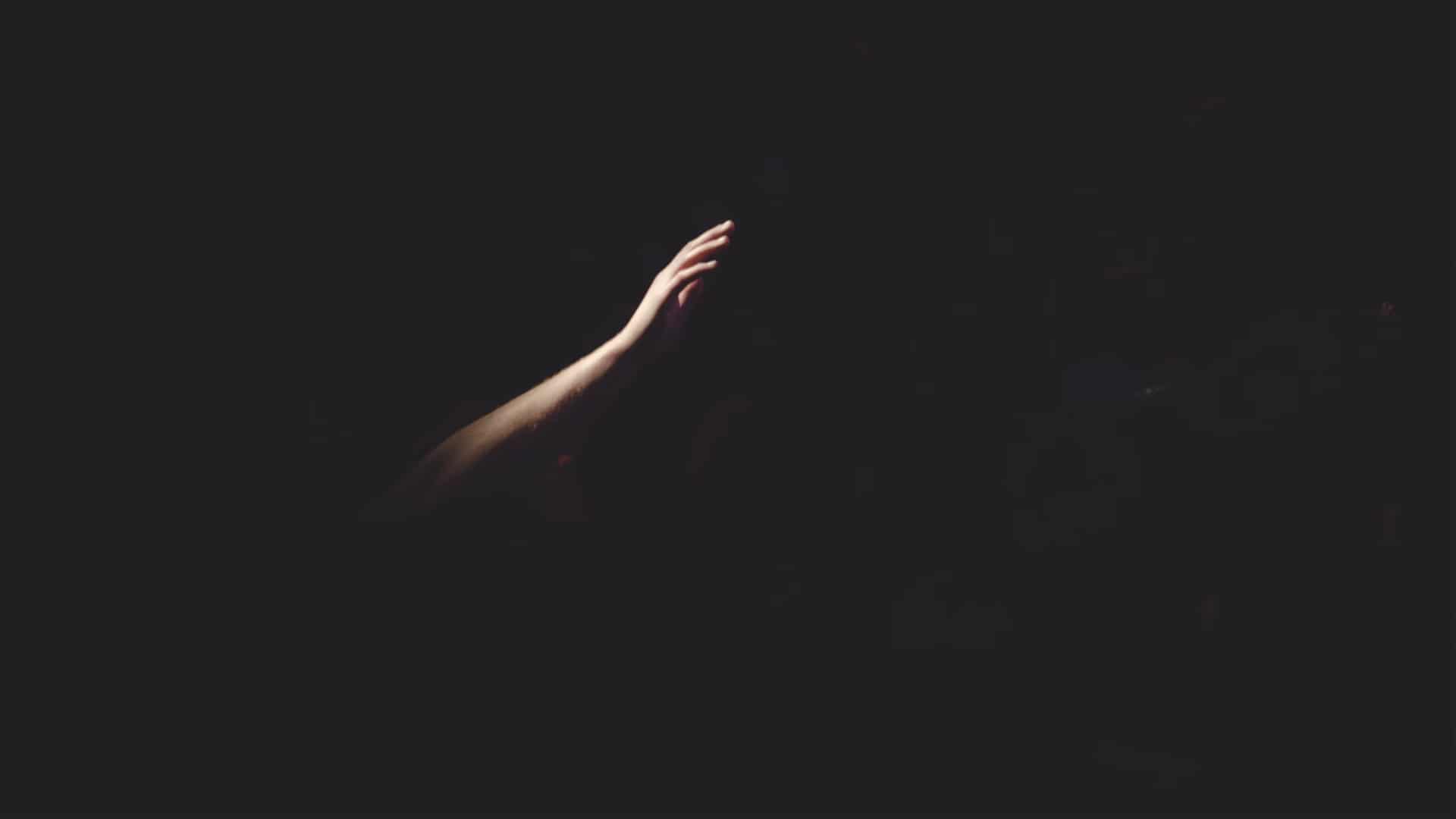 Lit hand in the darkness